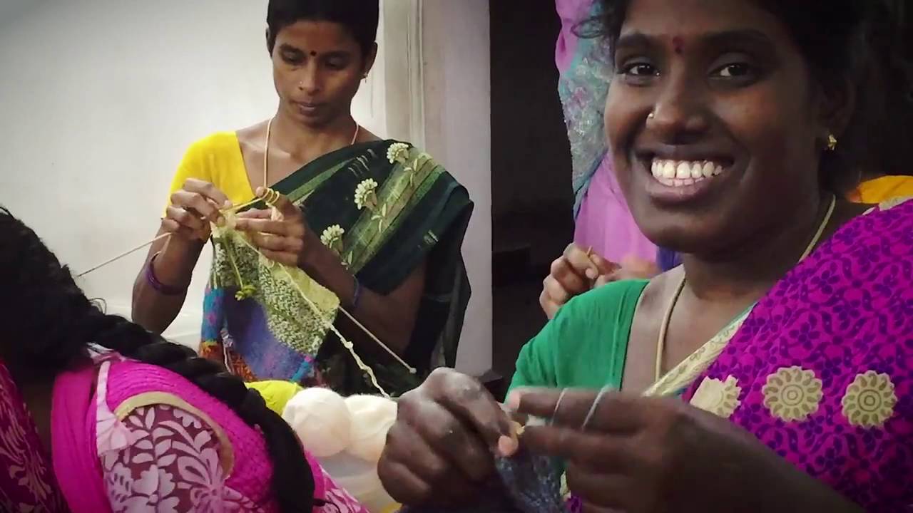Women engaged in traditional sewing activity.