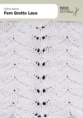 Graceful fern-like curves create a natural, flowing lace pattern with soft texture and rhythm Close-up of the Fern Grotto Lace handknit stitch pattern showing vertical, fern-like lace motifs in white yarn, creating a flowing, organic texture ideal for lace knitwear and nature-inspired stitch designs