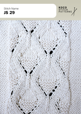 Flowing leaf-shaped cables and textured ridges create a graceful, dimensional handknit panel Close-up of the JS 29 handknit stitch pattern in white yarn, featuring elongated leaf-shaped cable motifs, textured ridges, and small eyelet openings