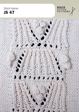 Framed bobble motifs and subtle lace create a balanced, decorative handknit panel Close-up of the JS 47 handknit stitch pattern in white yarn, showing framed bobble clusters, textured knit stitches, and small eyelet lace openings
