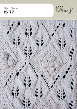 Raised bobble accents and leaf-shaped cables create a richly textured botanical handknit pattern Close-up of the JS 77 handknit stitch pattern in white yarn, featuring raised bobble clusters, leaf-shaped cable motifs, and eyelet lace openings
